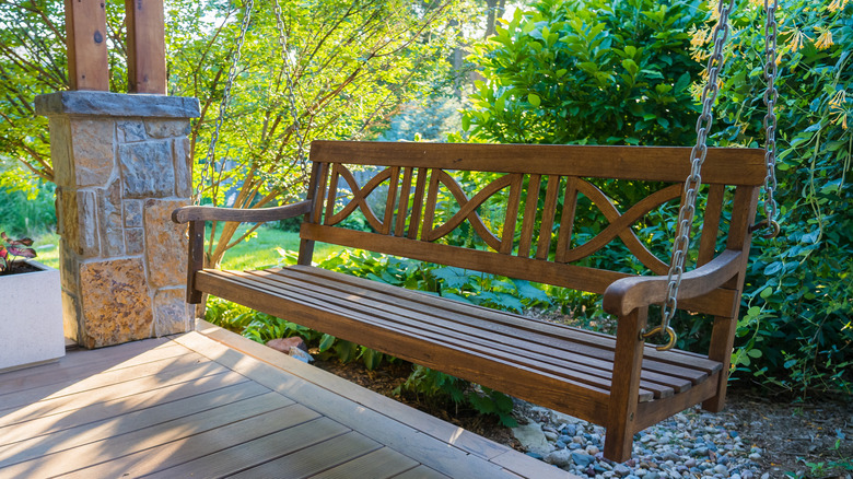 wooden hanging bench on porch