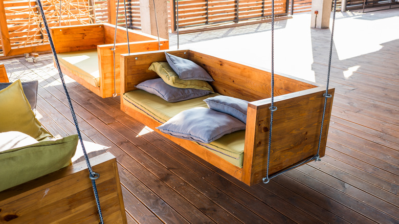 wooden hanging sofas on porch