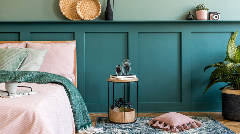 Teal baseboards pink bedding bedroom