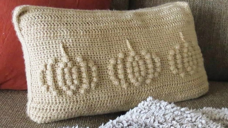 beige crocheted pumpkin throw pillow