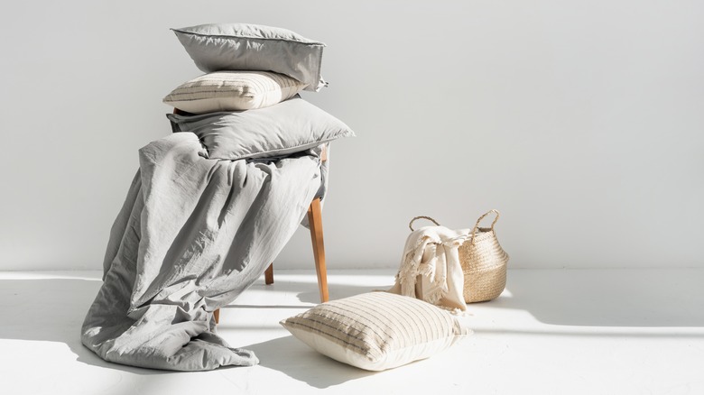 Pillows stacked on chair