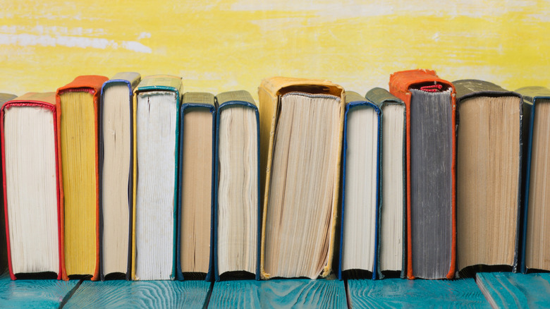 Books stacked against cables