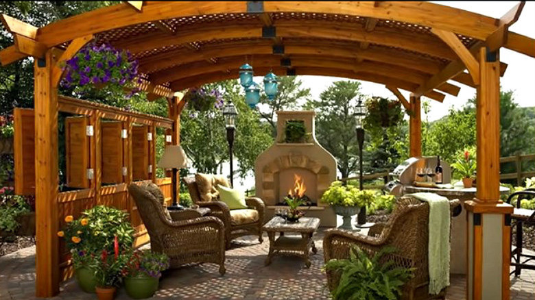 Stone fireplace behind a pergola