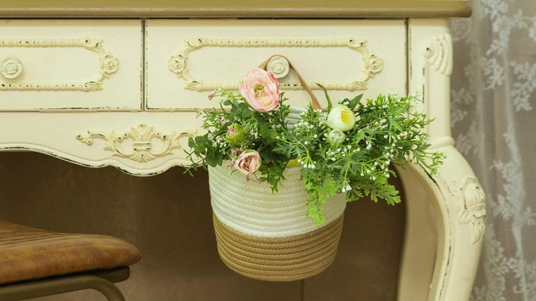 A woven basket hangs on a dresser