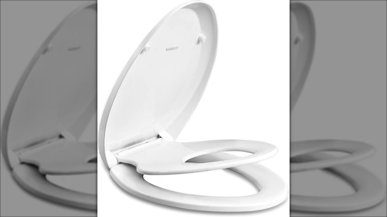 A product shot of a built-in potty training toilet seat