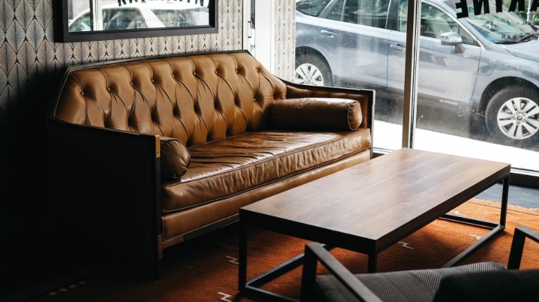 Leather button-tufted sofa with wood