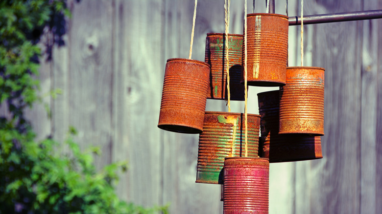 Wind chimes made from old, rusty tin cans.