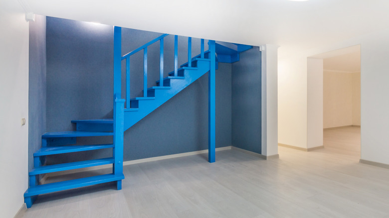 Blue staircase leading to basement