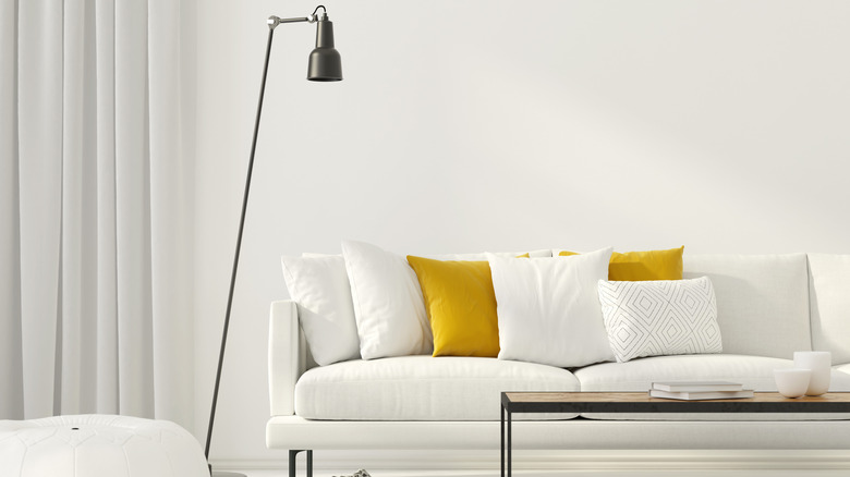 yellow pillows on white couch