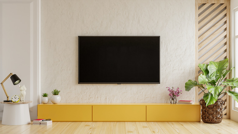 yellow entertainment center beneath TV