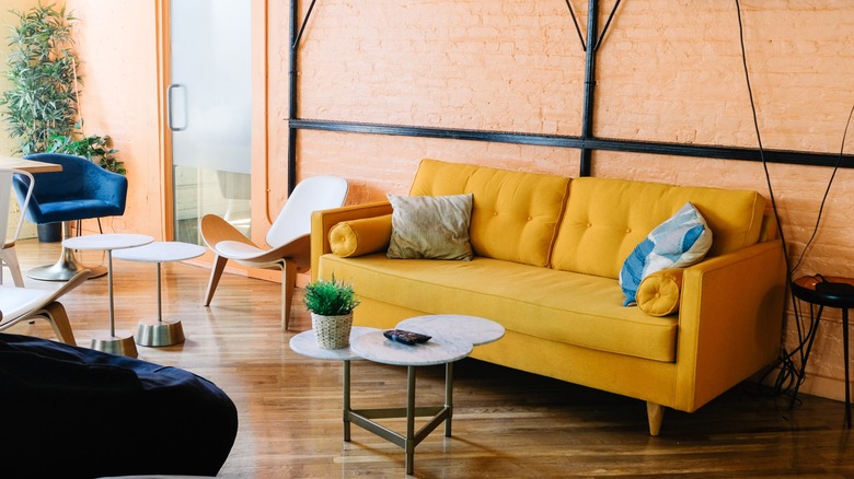 Yellow couch industrial apartment