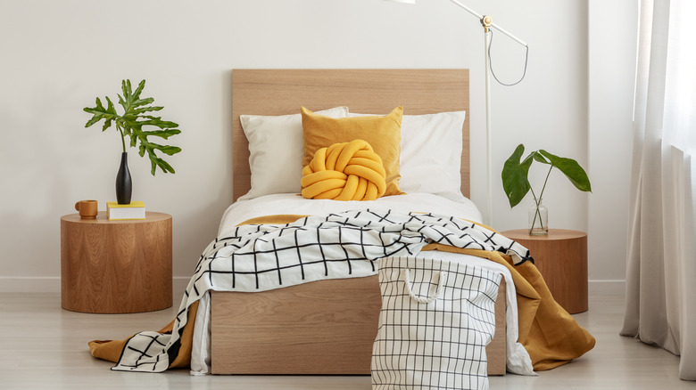 Bed with yellow throws