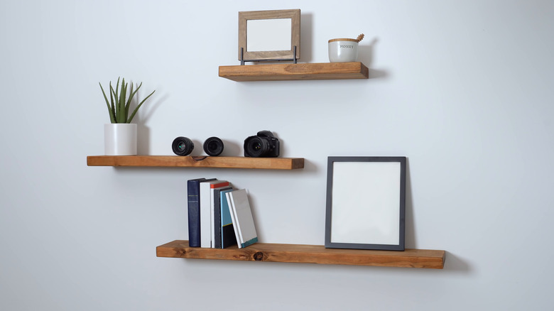 three brown floating shelves