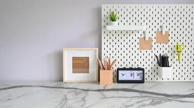 pegboard behind a marble desk