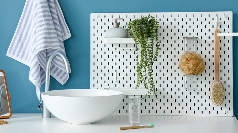 pegboard behind sink in bathroom