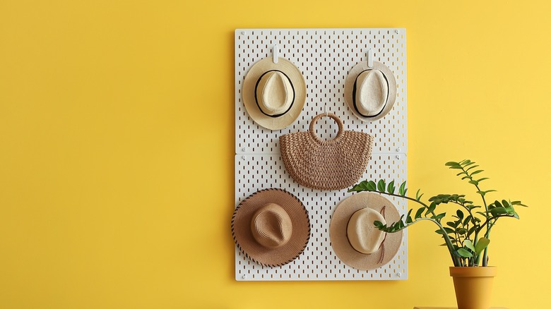 hats and bag on pegboard