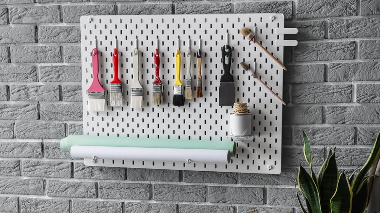 paintbrushes on a pegboard