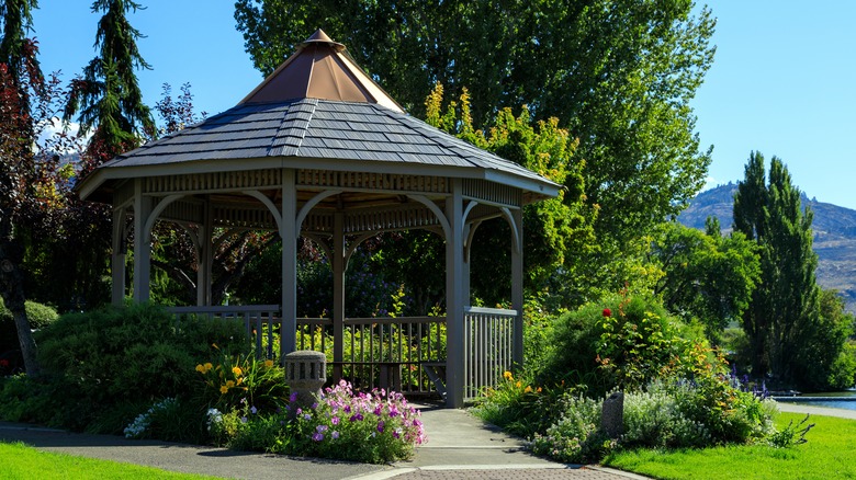 large gazebo surrounded by flowers