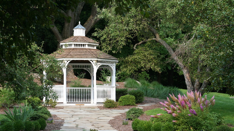 white gazebo with shingled roof