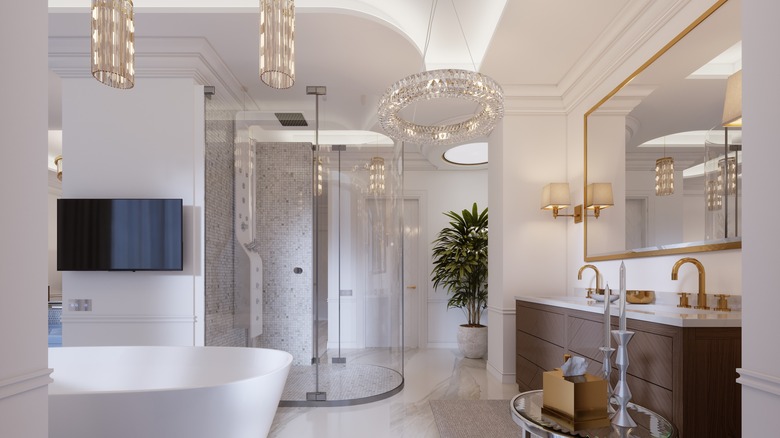 bathroom with chandelier and tub