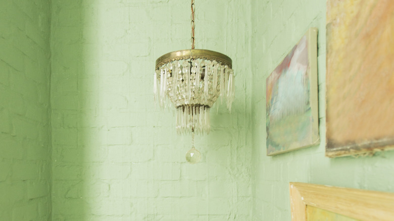 chandelier with green walls