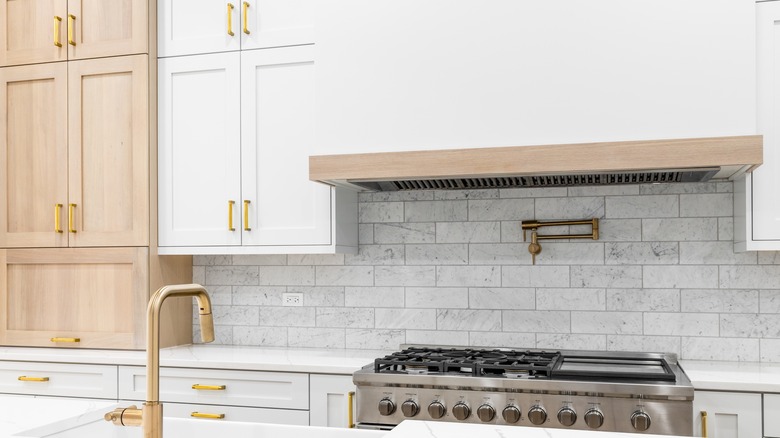 White, gold, and wood kitchen