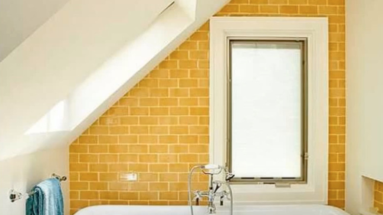 Yellow tile fills in bathroom