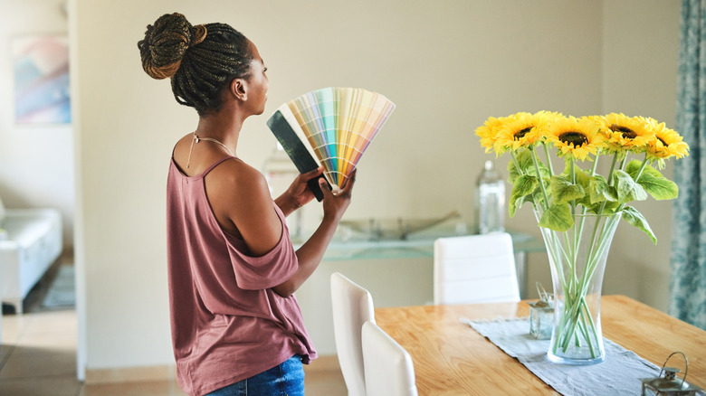 Someone trying to choose a color for her home