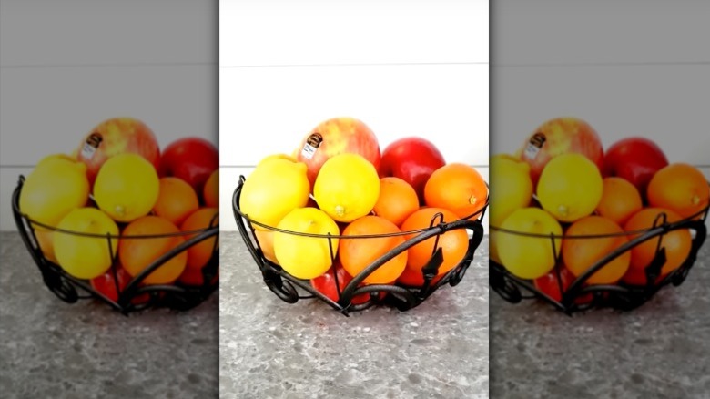 A fruit bowl made from a Dollar Tree garden fence and hanging basket