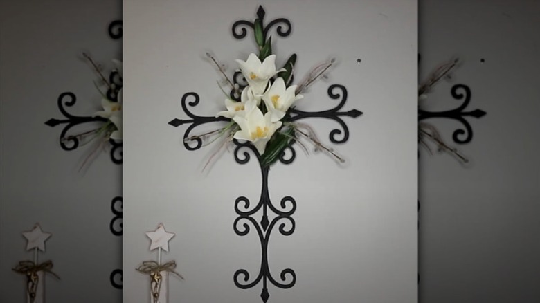 A Gothic or medieval cross wall decor made from Dollar Tree garden fence and faux flowers