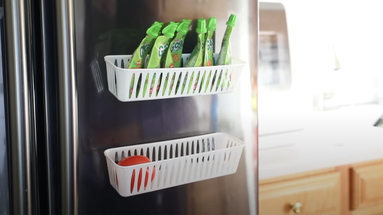 DIY magnetic storage shelves stuck on the side of a fridge.