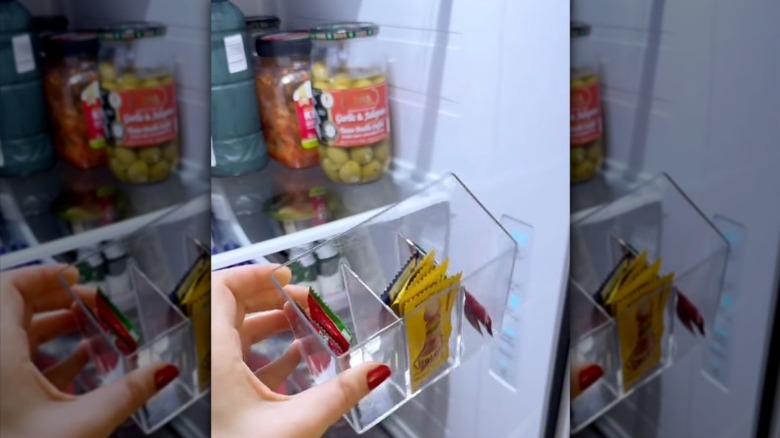 Person stores condiment sachets in a stationery organizer in the fridge.