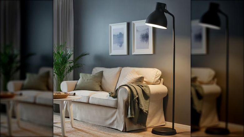 black spotlight lamp and sofa