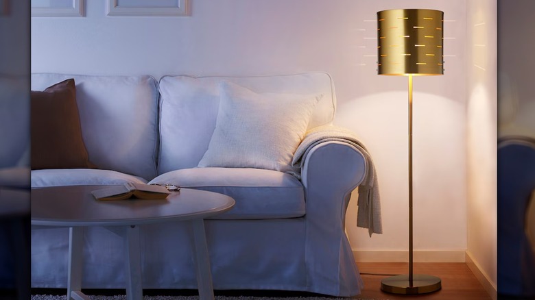 gold floor lamp and sofa