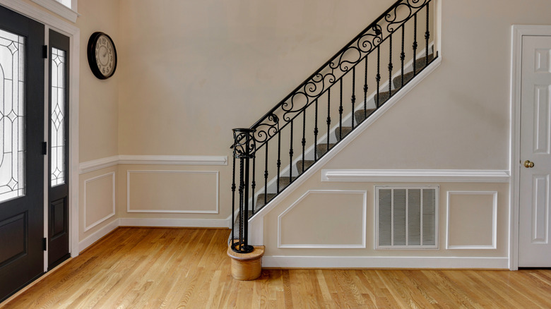 A well-lit entryway with staircase in front of door