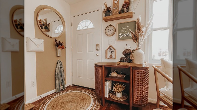 A small entryway with wooden table and vertical decorations