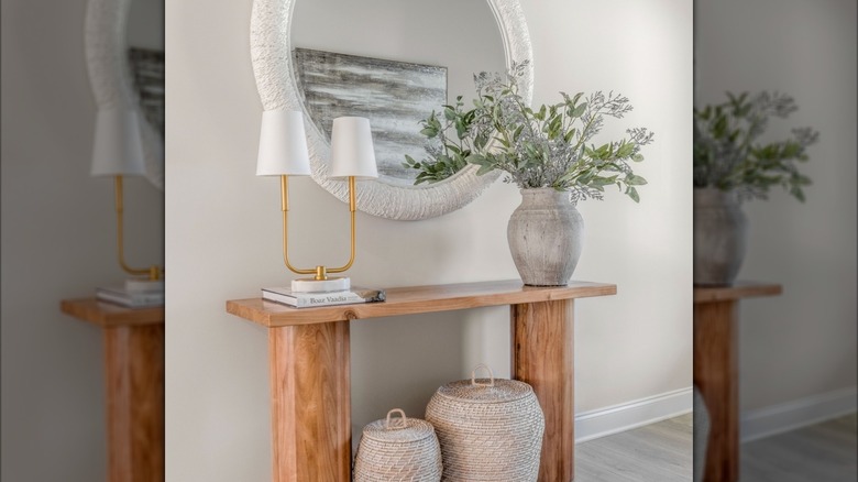 An understated entryway table with table and vase