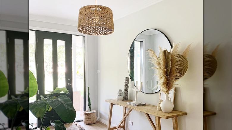 A wicker pendant light in a boho entryway