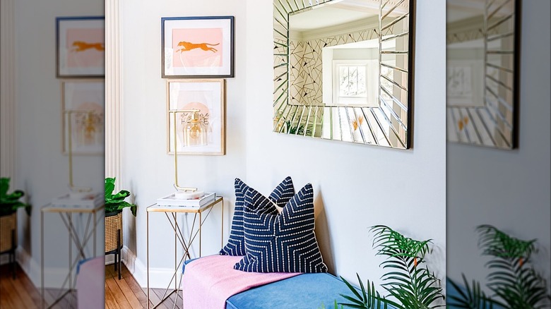 Bright entryway with mirror, picture frames, and bench