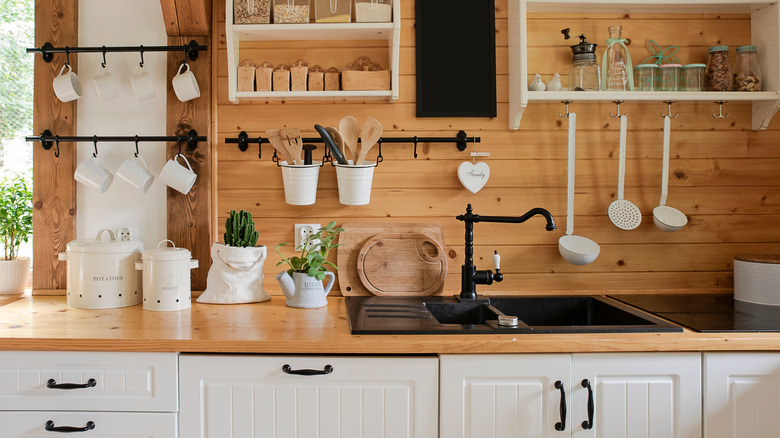 https://www.housedigest.com/img/gallery/22-beautiful-kitchen-sink-ideas-to-transform-your-space/black-drainboard-sink-1675502572.jpg