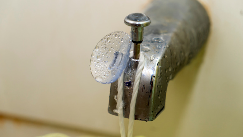 string hanging from silver faucet