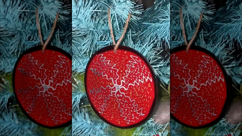 red plastic ornament on christmas tree