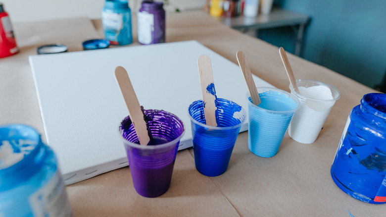 blue paints in plastic cups