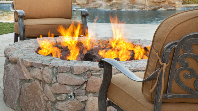 stone fire pit near pool