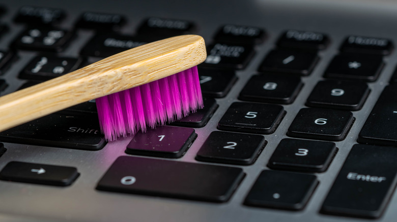toothbrush on computer keyboard