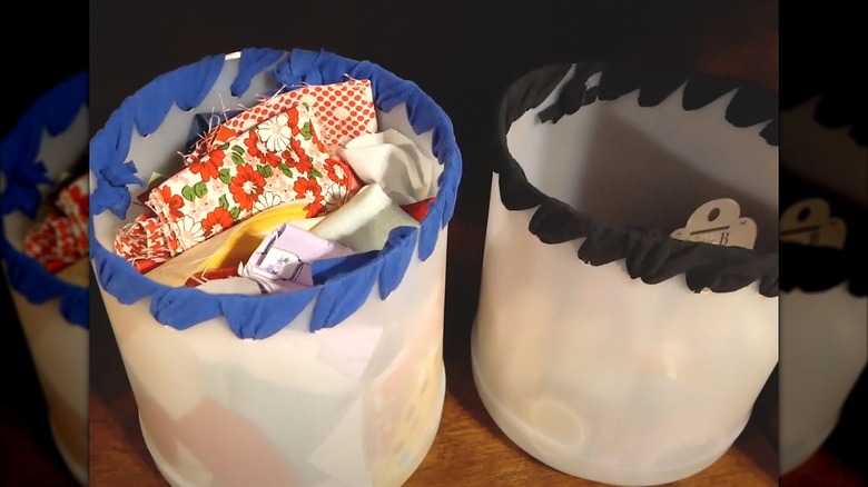 Two plastic vinegar jugs cut into bins to use for craft supply storage.