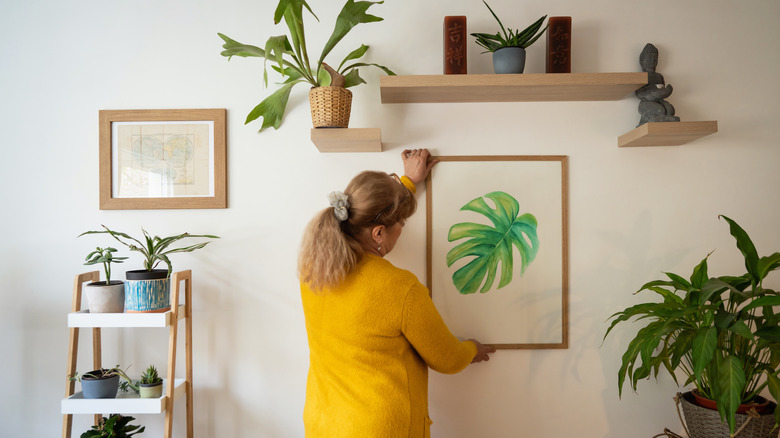 woman decorating house with painting