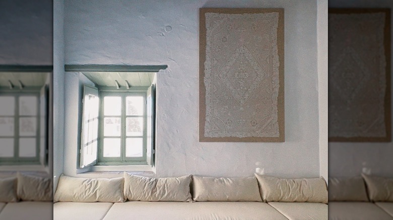 framed lace tablecloth on wall