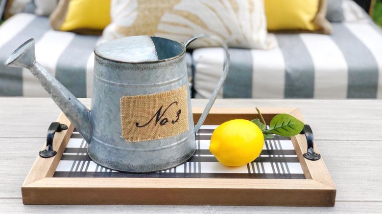 metal watering can on table