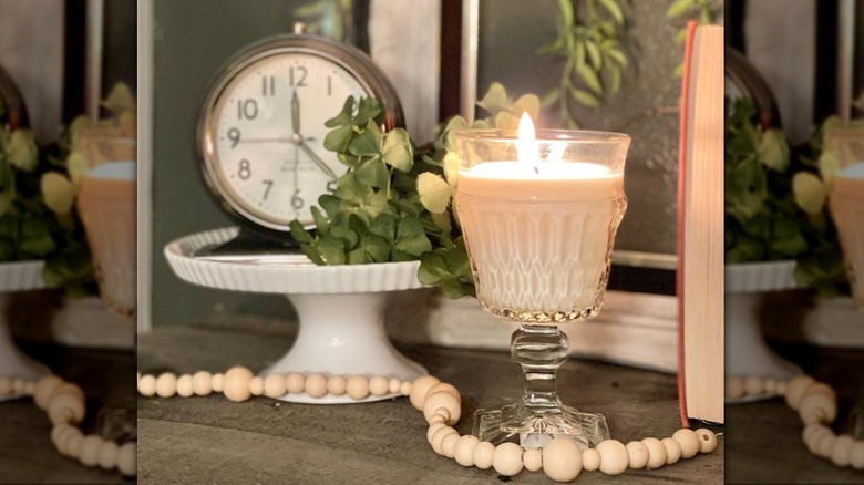 candle poured in clear wine glass